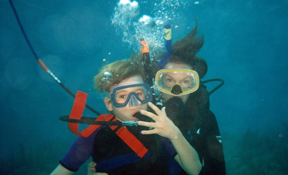 Wendy takes Christopher on his first diving adventure using a hookah.